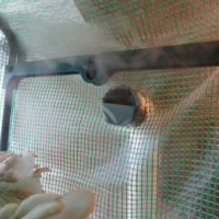 On right, note that a piece of duct tape covers half of the opening of the PVC pipe situated halfway up the martha. This covering helps push humidity up the pipe to the second, higher outlet near the top of the martha.